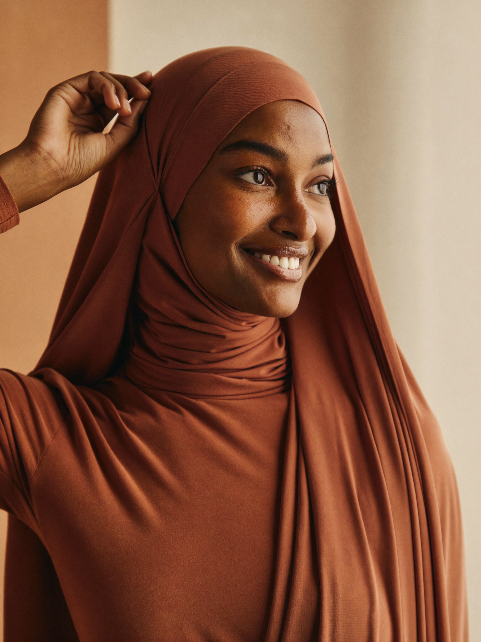 Pleated rayon scarf + bucket hat combo worn by Fatima